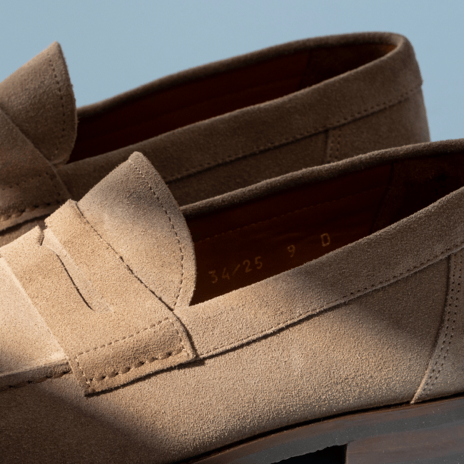 Men’s gray textured leather sneaker with tan rubber sole and brown leather lining