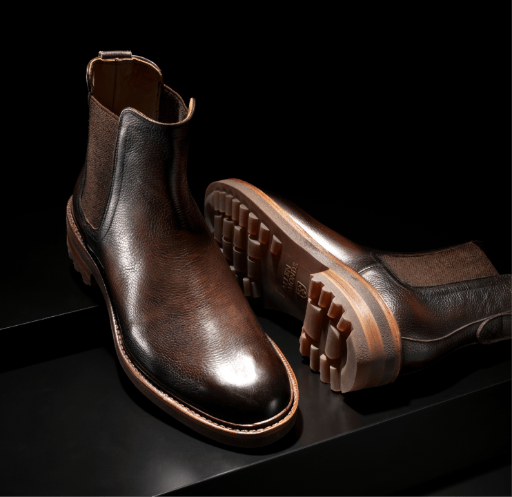 Dark brown leather Allen Edmonds Nash Chelsea boots against a dark background